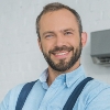 smiling-bearded-repairman-posing-with-crossed-arms-9WEV98W-1.jpg