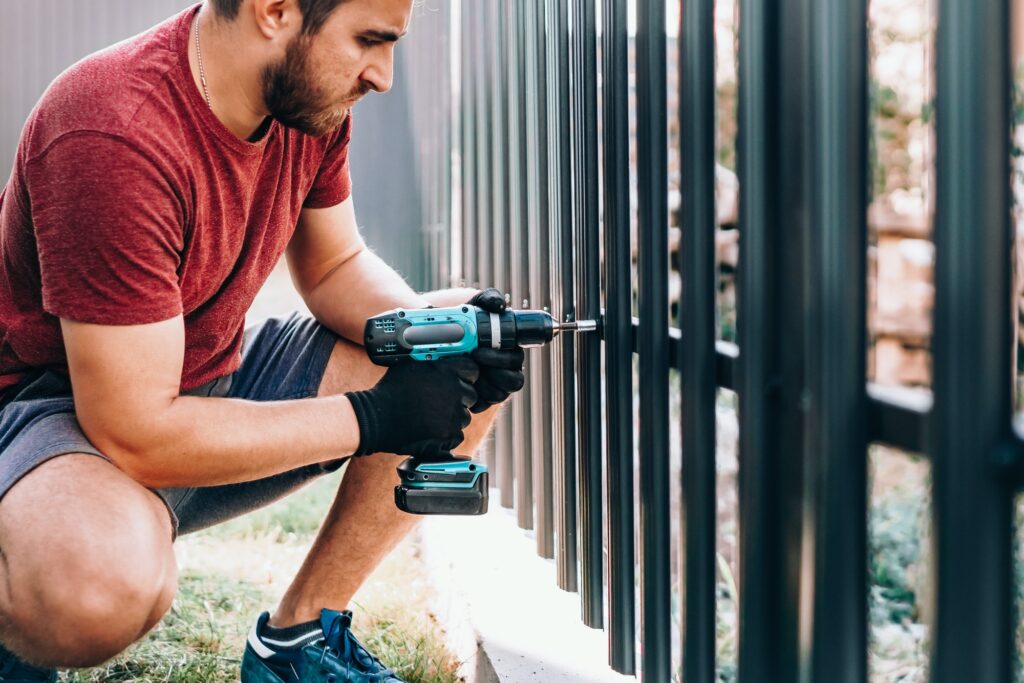 worker working with an electric screwdriver on the construction site