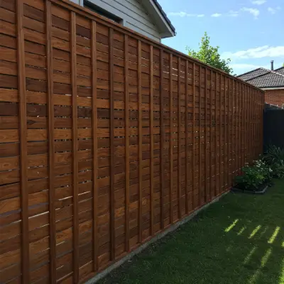 Vertical slat fencing in a modern wood finish, offering stylish privacy and clean lines for contemporary backyard spaces