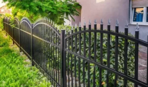 Decorative wrought iron fence installed around a residential property, offering elegant design with enhanced security and durability