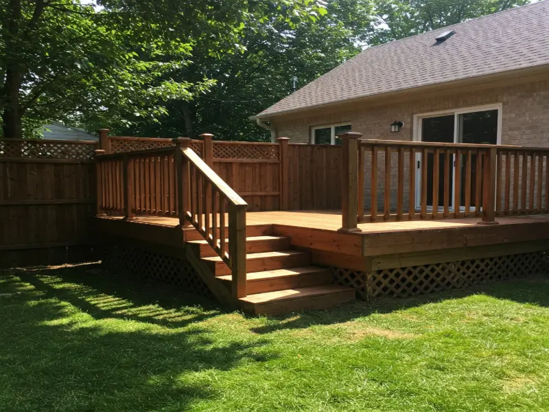Fence and deck combination featuring a wooden deck with a matching privacy fence, creating a cohesive and functional outdoor living space